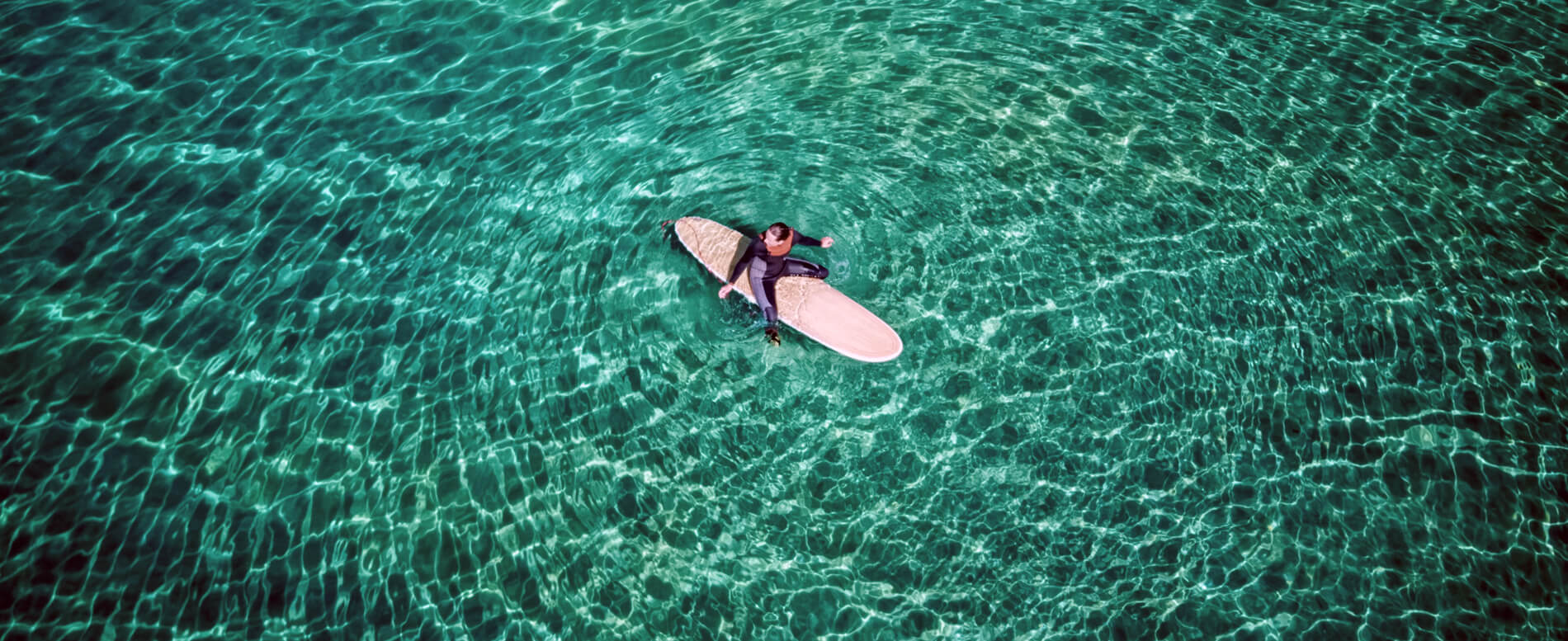 Man riding his paddle board on the middle of sea