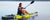 Woman kayaking using an inflatable paddle board