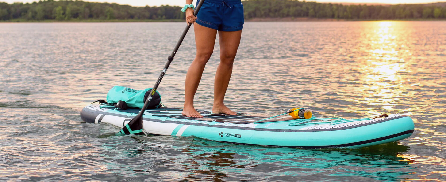 Woman paddle boarding on a lake